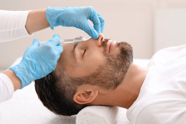 Middle-aged businessman getting injection in his nose